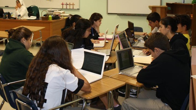 Salesian Sister Teresa Gutierrez's class researches their group's topic for their SIAW project. Sister Gutierrez is part of Immaculata-LaSalle's theology department as well as co-moderator for the freshman class.