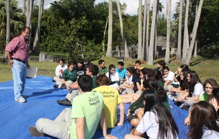 Teacher Danilo Recino, of Immaculata-La Salle's theology department, leads a group of students in their daily prayer experience at one of the campus' outdoor yards.