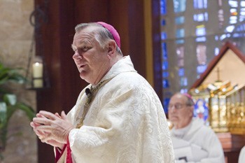 Archbishop Thomas Wenski greets the congregation at the beginning of Mass.