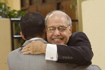 Bishop Felipe Estevez gets a hug from LJ Rodriguez after the luncheon.