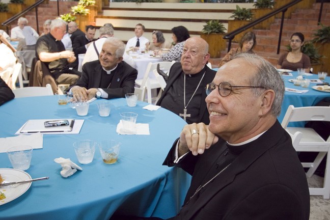 Enjoying the musical presentation during the lunch, from left: retired Auxiliary Bishop Agustin Roman, Archbishop Emeritus John C. Favalora and Bishop Felipe Estevez.
