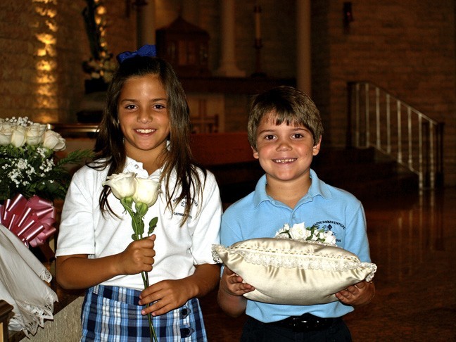 Second graders Leeza Maloney and Kurtis Ford seem excited and blessed to have been chosen to crown the Virgin Mary, at St. Bonaventure School
