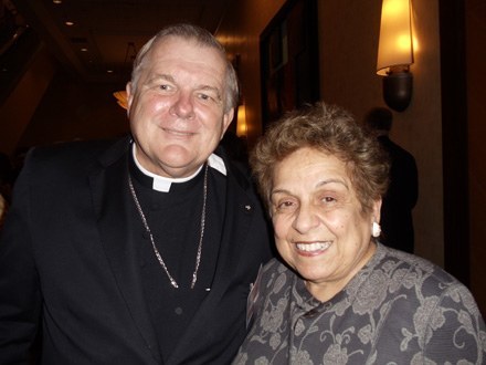 After the Mass, Archbishop Thomas Wenski poses for a photo with University of Miami President Donna Shalala, keynote speaker at the reception which followed.