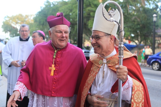 Archbishop Thomas Wenski and Bishop Felipe Estévez exchange pleasantries after the vespers ceremony.