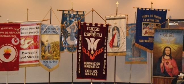 A row of banners represents each of the different Hispanic charismatic groups within the Archdiocese of Miami.