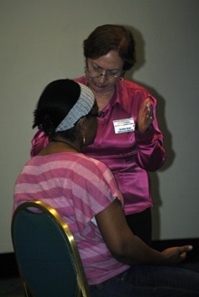 Prayer team member Yolanda Rojas prays for a participant at the conference.