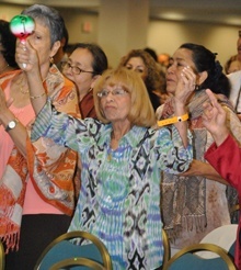 Virginia Nunez of St. Edward Parish in Pembroke Pines shakes a maraca to the beat of the music.