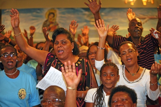 Worshipers sing happily during the Mass.