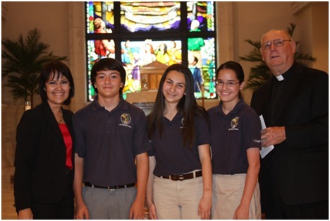 Cari Canino, St. Gregory principal, and St. Gregory's pastor, Msgr. Noel Fogarty, pose with the national math competition winners, seventh-grader Juan Rincon and eighth-graders Christina Wells and Karina Fernandez.
