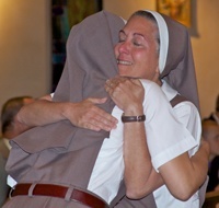 After vesting with the full habit, Sister Grace Marie of the Triumph of Crucified Love receives a hug from Mother Adela Galindo, foundress of the Servants of the Pierced Hearts of Jesus and Mary.