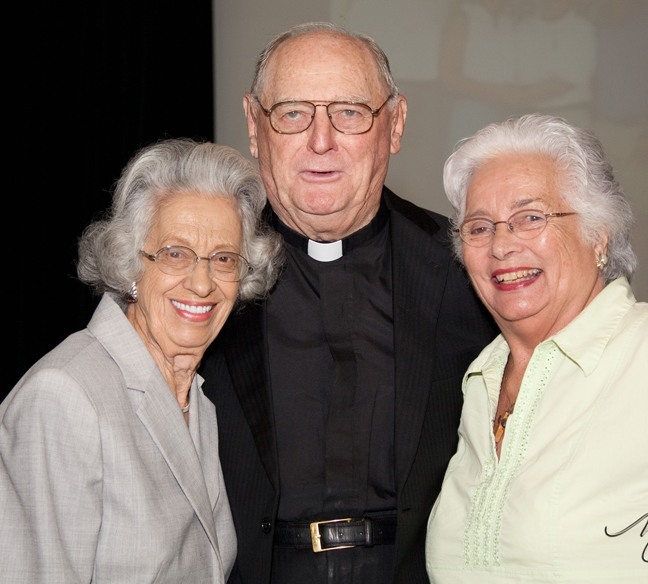 Msgr. Noel Fogarty poses after his retirement Mass with Ann Schandelmayer and Connie Sessions, who have been parishioners at St. Gregory since the 1960s.