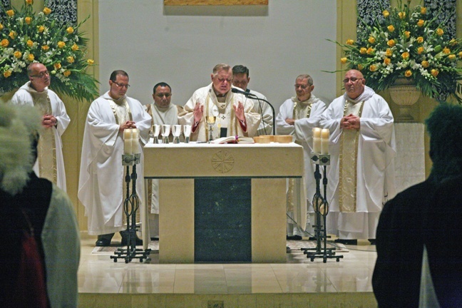 From left: Father Jorge Presmanes, Father Marcelo Solorzano, Deacon Alex Lam, Archbishop Thomas Wenski, Father Richard Vigoa, Father Restituto Perez and Father Alberto Rodriguez, pastor, take part in the Mass celebrated on St. Dominic's newly-consecrated altar.
