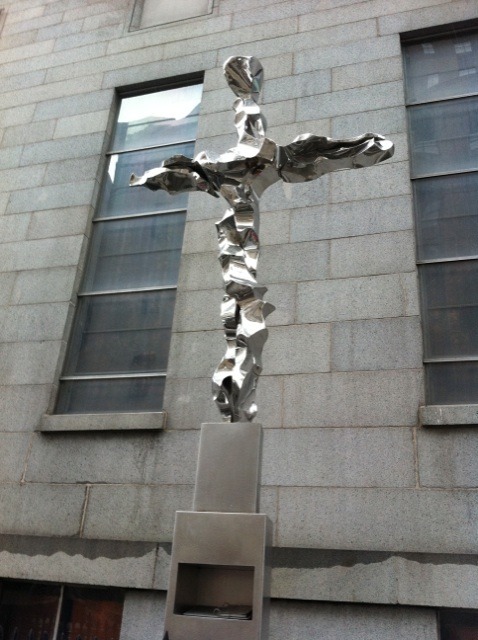 This is the Memorial Cross on the side of St. Peter's Church that faces Ground Zero. In the niche is a book made of steel plates engraved with the names of those who were born to Eternal Life.