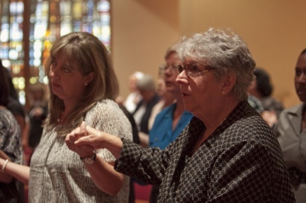 Sister Vivian Gomez, Sisters of St. Philip Neri and principal of St. Jerome School in Fort Lauderdale, holds hands with fellow principals during the Our Father.
