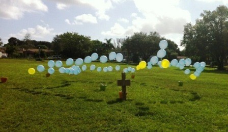 This picture shows the balloon rosary, with blue and yellow beads, created by students at Blessed Trinity School, Miami Springs.