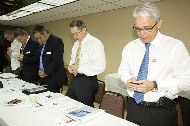 Synod team members focusing on the permanent diaconate begin their meeting with the Synod prayer: From left: John Clarke of Nativity Parish, Jim Duggard of St. Louis Parish, and Javier Inga of St. John the Apostle, all deacons in formation; and Deacons Ernesto Del Riego of St. Agatha and Roberto Fleitas of Little Flower in Coral Gables.