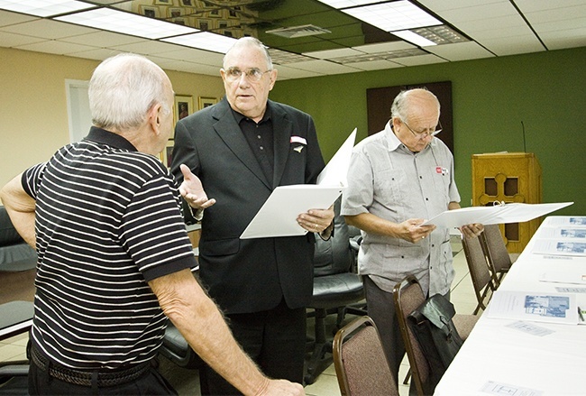 Deacon Dennis Jordan, center, of Blessed Trinity Parish speaks with Deacon Carl Carieri of St. Maximilian Kolbe as Deacon Roberto Pineda of St. Joseph Parish looks over the Synod focus team documents.