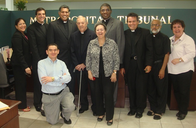 Father Jose Biain, fourth from left, poses with fellow members of the Tribunal staff, from left: Goretti Anthony, secretary; Msgr. Michael Souckar, adjutant judicial vicar; Roberto Aguirre, kneeling, case director; Father George Puthusseril, judicial vicar; Katia Arriaza, notary; Father Jude Ezeanokwasa, judge; Father Alvaro Pinzn and Father Mathew Thundathil, defenders of the bond; and Maite Lenoz, receptionist.