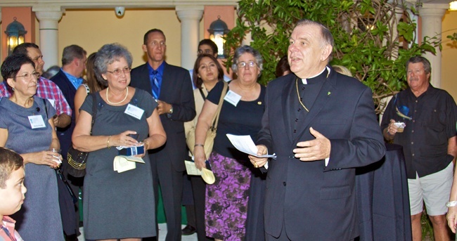 Archbishop Thomas Wenski speaks to Virtus facilitators gathered at a reception held after a Mass in their honor at St. Mary Cathedral.