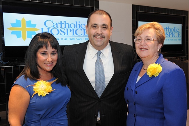 Maylen Montoto, left, director of Community Development for Catholic Hospice, and Bonnie Alkema, executive director of Catholic Hospice, pose with Alfredo Mesa, executive director of the Marlins Foundation. The Miami Marlins Foundation staged a cocktail reception Nov. 8 to celebrate the Moyer Foundation grant that will enable Catholic Hospice to stage Camp Erin, a free bereavement camp for kids, twice a year in South Florida.