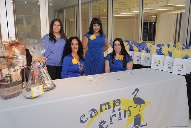 Catholic Hospice employees Amy Baena, Inma Murga, Maylen Montoto and Gloria Gamez get ready to greet guests at the Camp Erin reception at Marlins Park.