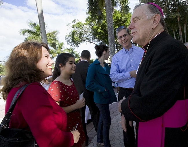 Archbishop Thomas Wenski greets ABCD donors prior to the start of the ThanksFORGiving Mass. Here he greets the Lantigua family from St Mark Parish in Southwest Ranches.