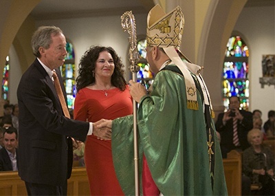 Archbishop Thomas Wenski gives the One in Hope award to Keith and Doreen Koenig of St. Gregory Parish in Plantation.