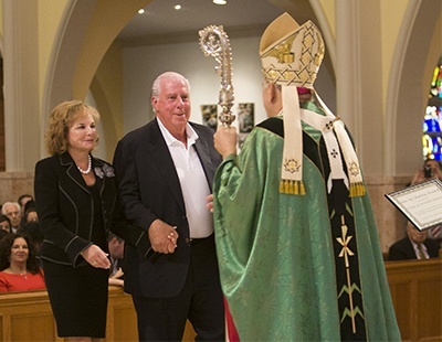 Archbishop Thomas Wenski gives the One in Charity award to Paul and Swanee DiMare of St. Hugh Parish in Coconut Grove.