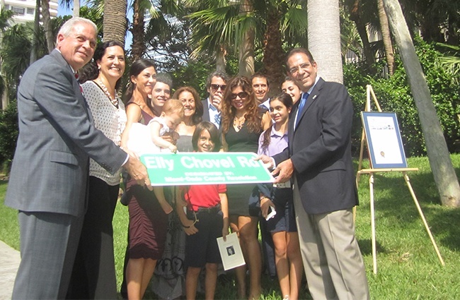 Miami Mayor Tomas Regalado, far left, and former mayor and now countr commissioner Xavier Suarez, far right, pose with Elly Chovel's daughter, Brigid Prio, second from left, during the dedication ceremony for the street named in Chovel's honor.