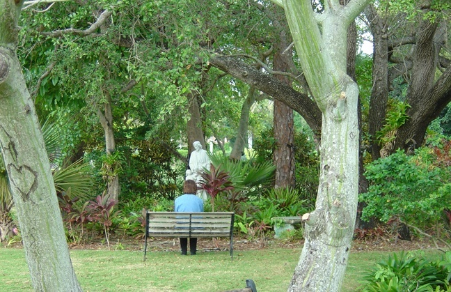 A retreat participant meditates in front of the Shrine of St. Joseph on the grounds of MorningStar Renewal Center.