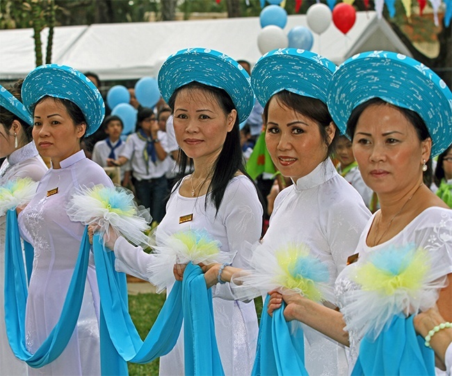 Vietnamese Apostolate ushers stand in front of the shrine during the blessing.