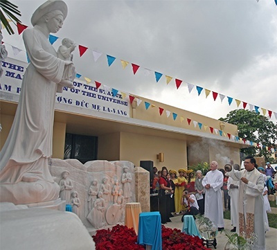 Father Joseph Long Nguyen, administrator of the Vietnamese Apostolate in the archdiocese, incenses the new statue of Our Lady of La Vang.