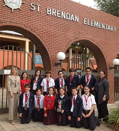 St. Brendan Elementary’s seventh graders pose with their medals and second place trophy after the Academic Olympics at Msgr. Edward Pace High School. At left is Elizabeth Furmanick, principal, and at far right is Maria Cristina Capote-Alonso, assistant principal.