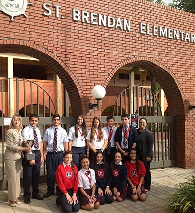St. Brendan Elementary’s eighth graders pose with their medals and first place trophy after the Academic Olympics at Msgr. Edward Pace High School. At left is Elizabeth Furmanick, principal, and at far right is Maria Cristina Capote-Alonso, assistant principal.