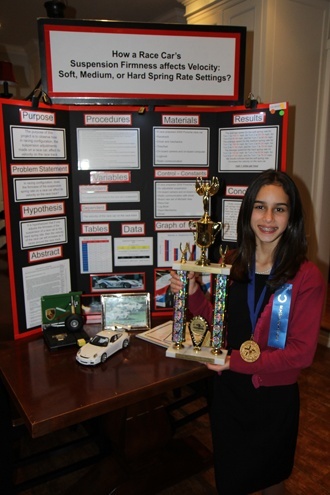 First place winner Daniela Rodriguez, a sixth grader at Blessed Trinity School, poses with her first place trophy. She will go on to represent Miami-Dade County and Blessed Trinity in the 57th annual Florida State Science Fair to be held in Lakeland this April. Daniela’s winning project was “How a Race Car’s Suspension Firmness Affects Velocity: Soft, Medium, or Hard Spring Rate Settings."