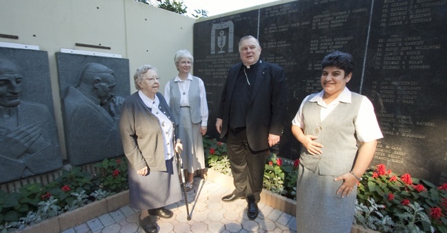 The general moderator of the Sisters of Social Service, Sister Agnes Pataki (second from left), visited members of her community in South Florida this month and stopped by the Pastoral Center Jan. 24 to meet with Archbishop Thomas Wenski. Pictured here in the Garden of Memories at the Pastoral Center is the archbishop with Sister Pataki, Sister Suzanne Simo (far left), a retired sister living in the archdiocese who worked for 30 years at Centro Hispano Catolico in Miami, and Sister Yillian Gonzalez, one of 19 Sisters of Social Service working in Cuba. Sister Gonzalez, who works in El Cobre, was visiting her family in Miami. Another member of the community, Sister Irmina Rojas, also is retired in Miami but continues to volunteer at Centro Mater, where she served for many years. The archbishop was showing Sister Pataki the plaque honoring Cardinal József Mindszenty, who suffered under communism in Hungary. Sister Pataki is a native of Hungary. The memorial plaques were commissioned by Archbishop Joseph P. Hurley of St. Augustine back when Miami was part of that diocese, and scuplted by Yugoslavian artist Ivan Mestrovic.