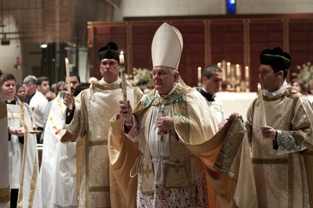 Archbishop Thomas Wenski walks in the candelmas procession.