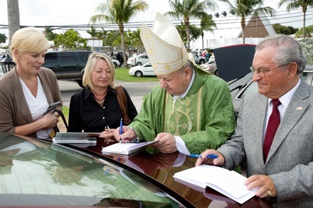 After Mass, Cardinal Stanislaw Dziwisz signs copies of his book, "A Life with Karol," for members of the Polish American community.