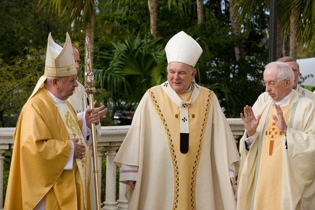 Cardinal Stanislaw Dziwisz chats with Archbishop Thomas Wenski and Msgr. John Vaughan, pastor of St. Patrick Church, Miami Beach, before celebrating Mass there Feb. 4.