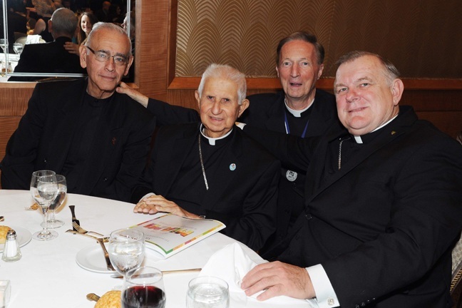 Retired Miami Auxiliary Bishop Agustin Roman, second from left, is shown here at the MCCJ Humanitarian dinner with his longtime master of ceremonies, Deacon Manolo Perez, far left, Archbishop Thomas Wenski, and Father Patrick O'Neill, director of interfaith and ecumenical affairs for the archdiocese (back, center).