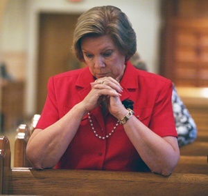 Joan, Director of the Respect Life Ministry, prays during Mass.
