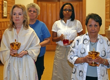 Kathy Weissinger, Evie Vanlengen, front,  Lidwina Witzenberg and Carole Garcia, in back, pregnancy center program coordinators, bring up the offertory during the Mass for nascent human life.