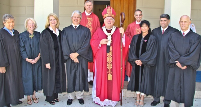 Archbishop Thomas Wenski poses with Key West and Monroe County judges after the annual Red Mass for the legal profession, celebrated at the minor basilica of St. Mary Star of the Sea in Key West. Behind them are Deacon Peter Batty and Father John Baker, pastor, of St. Mary Star of the Sea.
