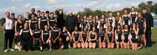 The Maverick Men�s and Women�s Track Team pose for a picture with Mascot Maverick, Father Brendan Dalton, supervising principal, center, head track coach David DiNicola, far left, and women�s track coach Terri Swanson, far right.