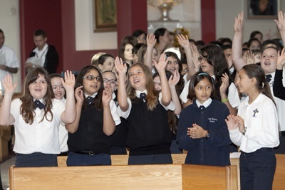 Sixth graders from Our Lady of the Holy Rosary School sing during Focus 11.