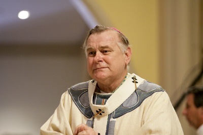 A visibly moved Archbishop Thomas Wenski processes into St. Mary Cathedral for Bishop Agustin Roman's funeral Mass.