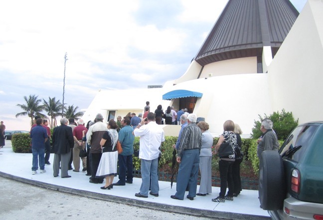 People line up outside the Shrine of Our Lady of Charity to view the body of Bishop Agustin Roman. Sometimes they stood in line for 30 minutes or longer. The crowds continued to come, day and night, for the nearly two days that his body lay in state.