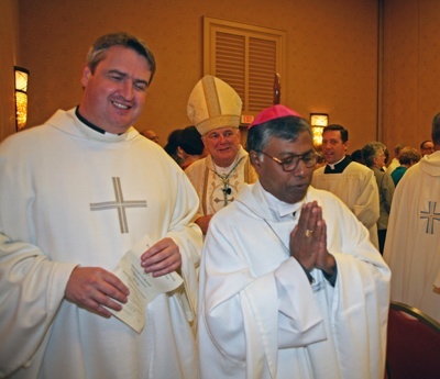 Oblate Missionary Father Andrew Small, left, national director of the Pontifical Mission Societies in the U.S., and Bishop Bejoy D'Cruze, OMI, of Sylhet, Bangladesh, precede Archbishop Thomas Wenski as they process out of Mass.