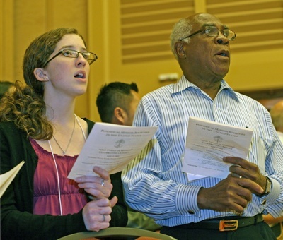 Rachel Barron and Dr. Rodrigue Mortel of the Archdiocese of Baltimore sing during the Mass.