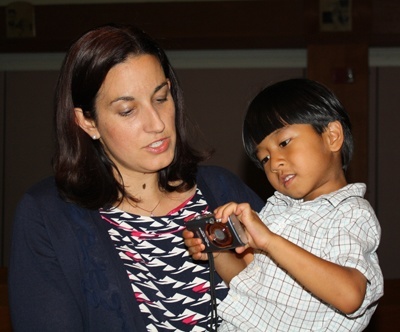 Angelique Ruhi-Lopez holds her son, Emmanuel, 5, at the end of the Mass.